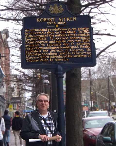 The author stands by the Robert Aitken historical marker in Philadelphia.