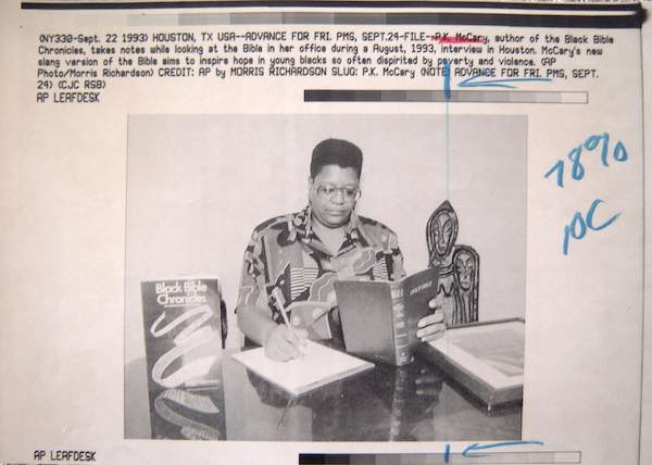 Press release photo for Black Bible Chronicles showing P.K. McCarey working at her desk. 1993.