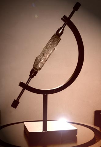 The author displays his Noah's Ark expedition cut sliver. He includes this in his live presentations when requested.