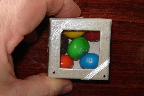 This box of candy pieces contains a photopolymer film which has the artistic image of Jesus Christ embeded within the hologram. A laser pointer can project the image.